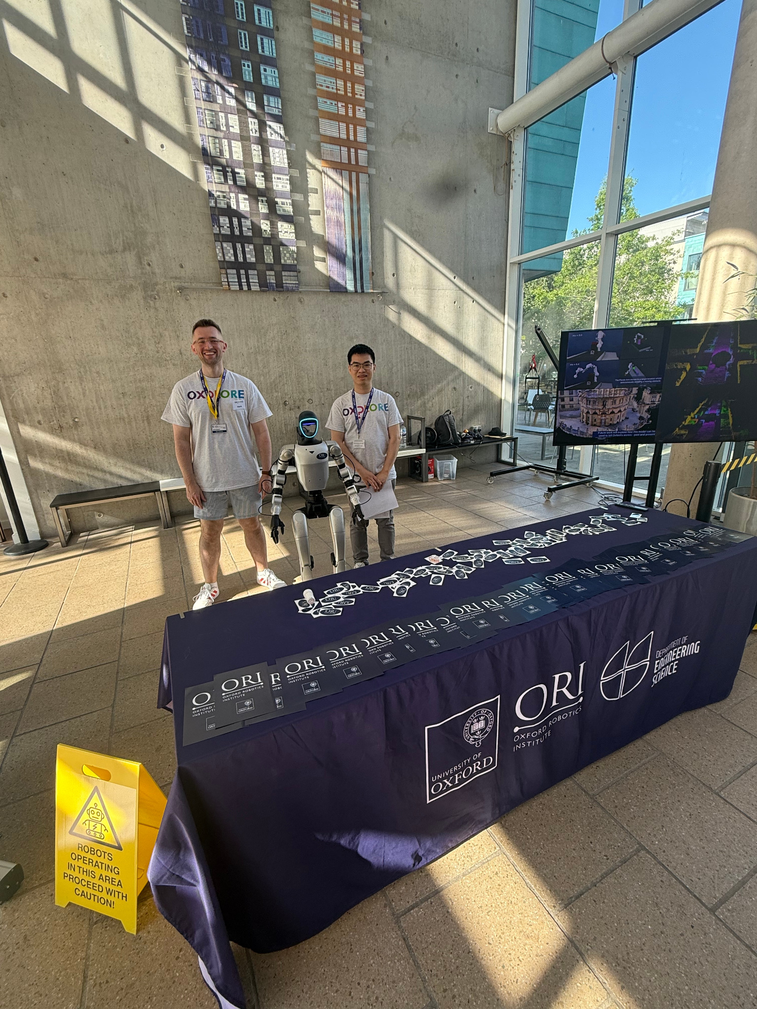 Mark Bromley and Kai Lu with the Unitree G1 robot at the ORI and Oxford Oxplore stand in Birmingham